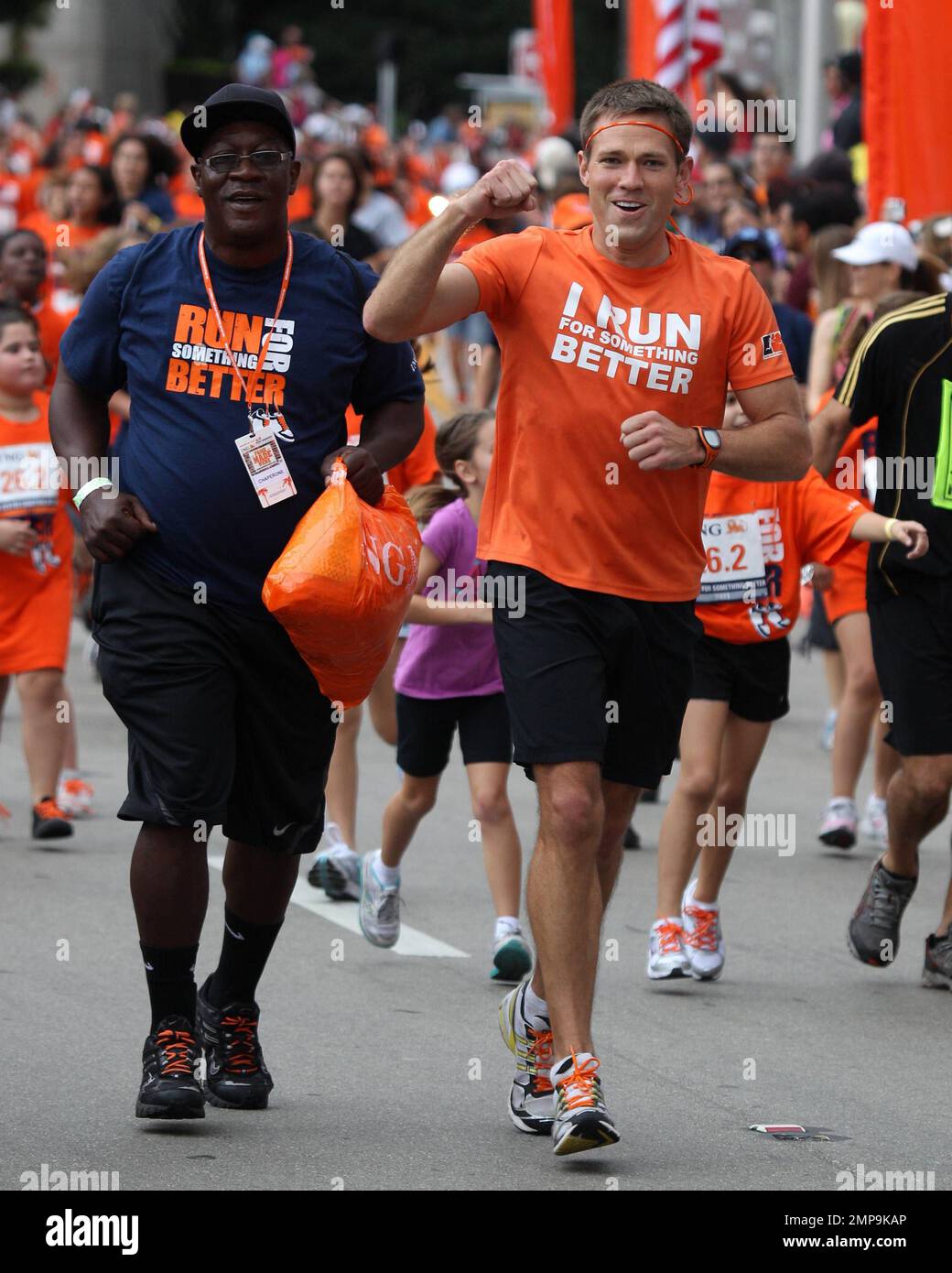 Lieutenant Commander Andrew Baldwin, M.D., a Naval physician and former star of the ABC hit series 'The Bachelor,' urges runners to cross the finish line in the ING Run For Something Better, a charitable initiative that promotes youth fitness and provides grants and funding for school-based running programs across the country. Miami, FL. 29th January 2012. Stock Photo