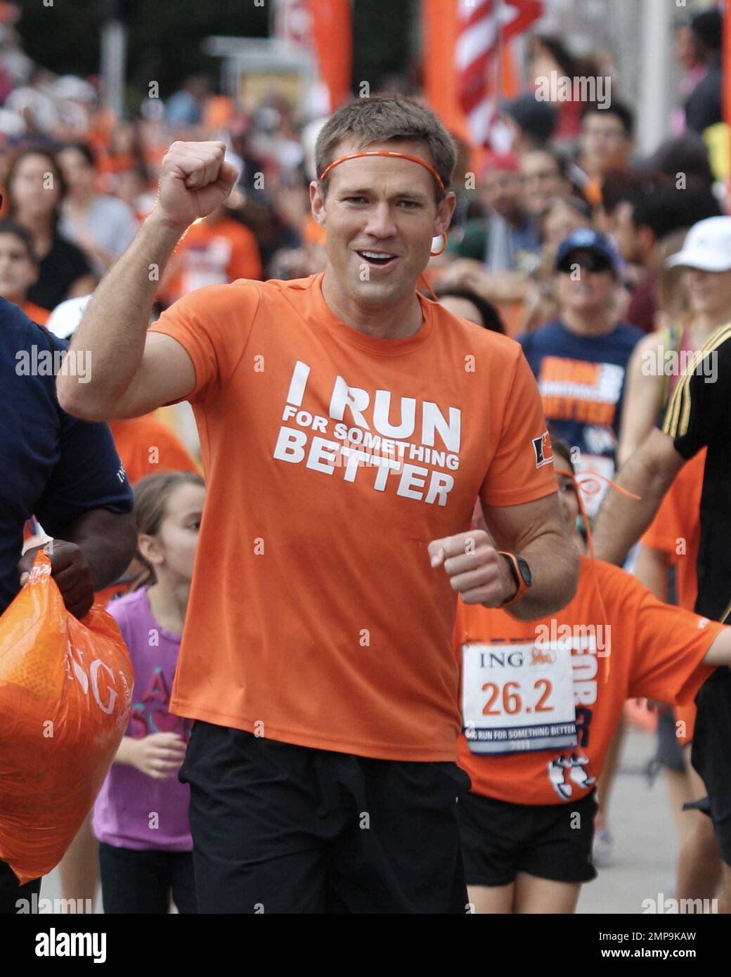 Lieutenant Commander Andrew Baldwin, M.D., a Naval physician and former star of the ABC hit series 'The Bachelor,' urges runners to cross the finish line in the ING Run For Something Better, a charitable initiative that promotes youth fitness and provides grants and funding for school-based running programs across the country. Miami, FL. 29th January 2012. Stock Photo