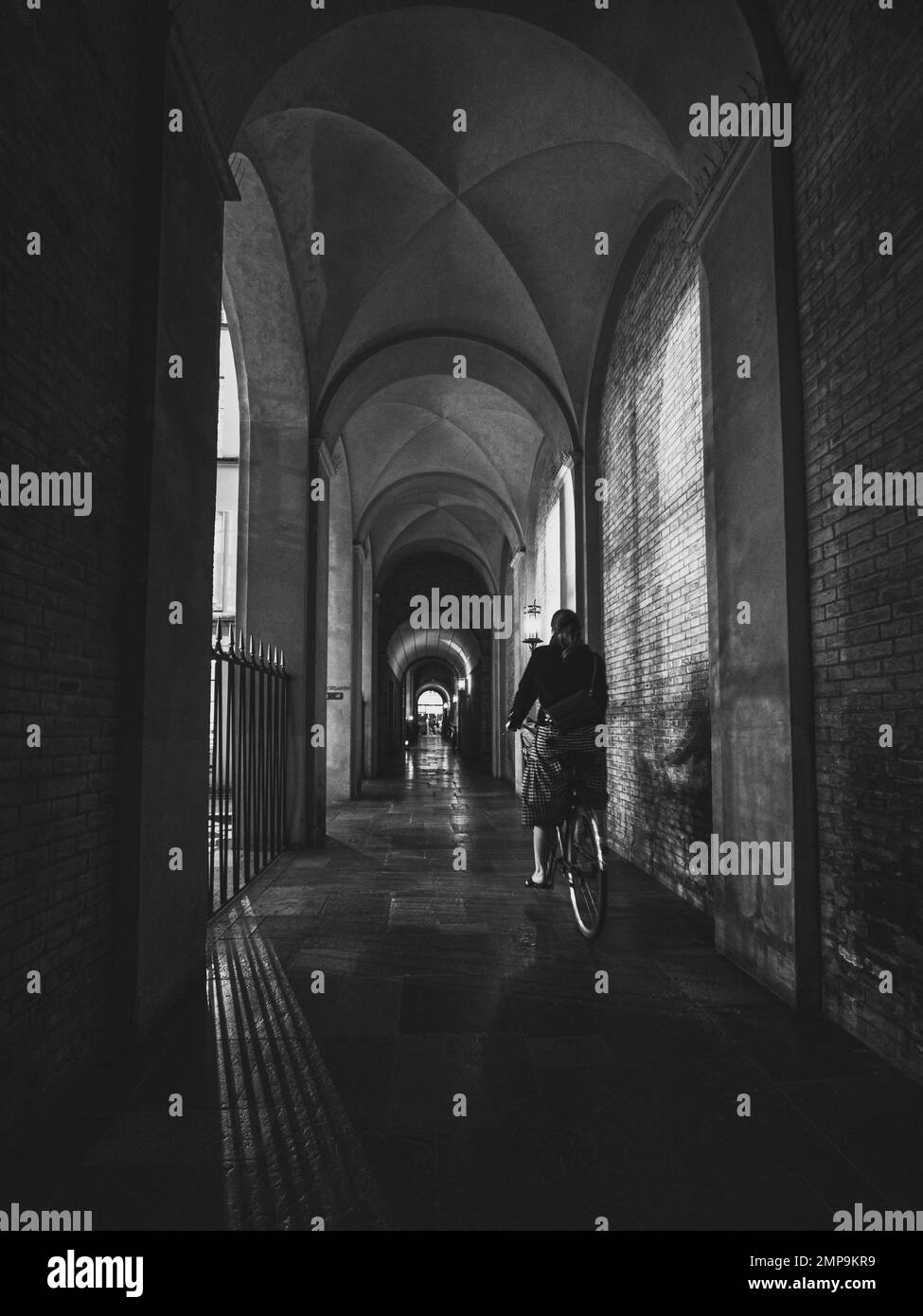 cyclist at old passageway with arcades in the city of Copenhagen Stock Photo
