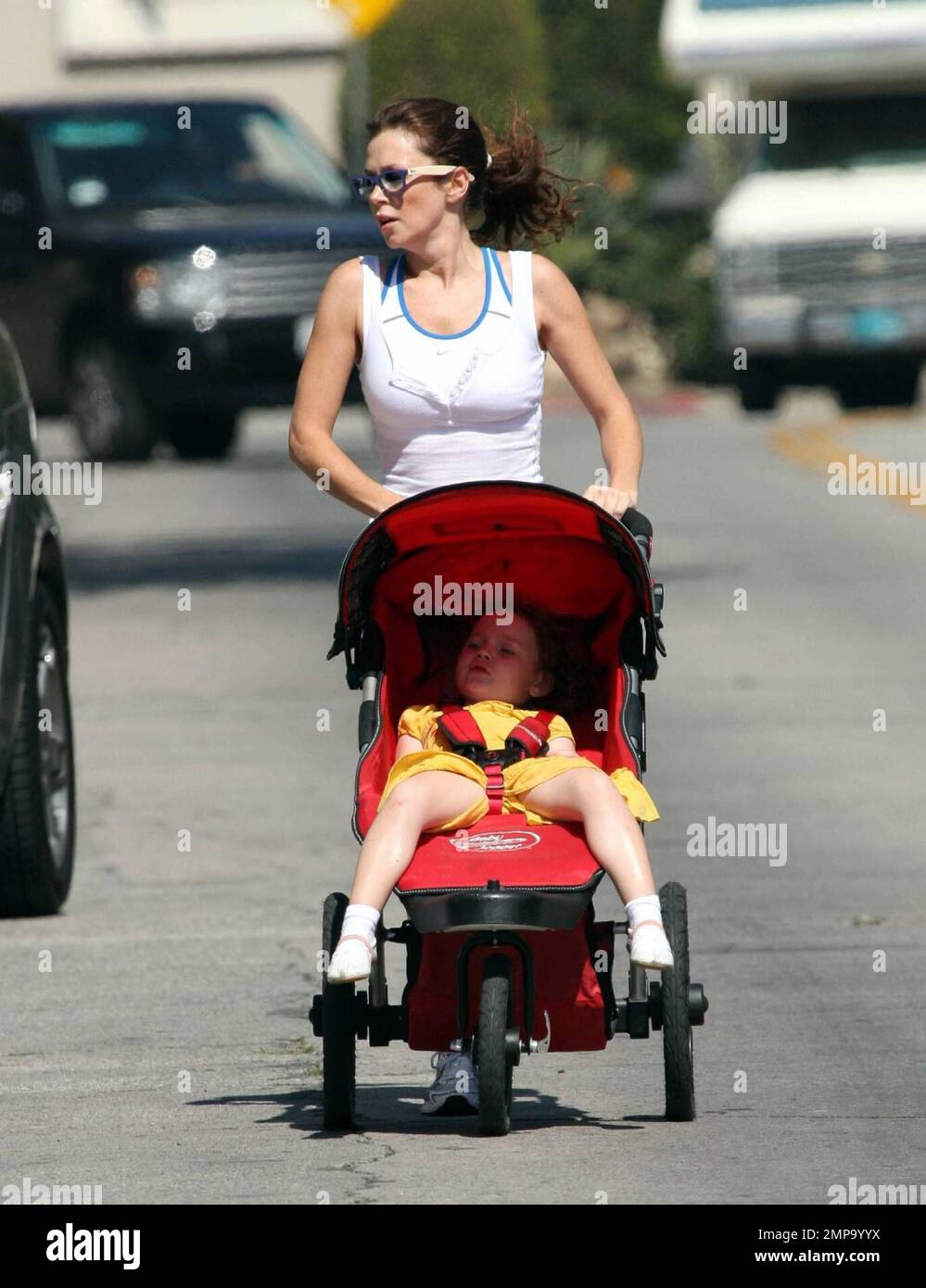 British actress and 'Pushing Daisies' star Anna Friel jogs around her neighborhood with her daughter Gracie and her mom [check].  Anna, who appears to be in great shape, ran for over a mile while pushing Gracie's stroller and barely breaking a sweat. Her pace was so fast that several of the photographers trying to shoot her could barely keep up with her. It seems that the sunny Southern California lifestyle really suits her. Los Angeles, CA. 10/9/08. Stock Photo