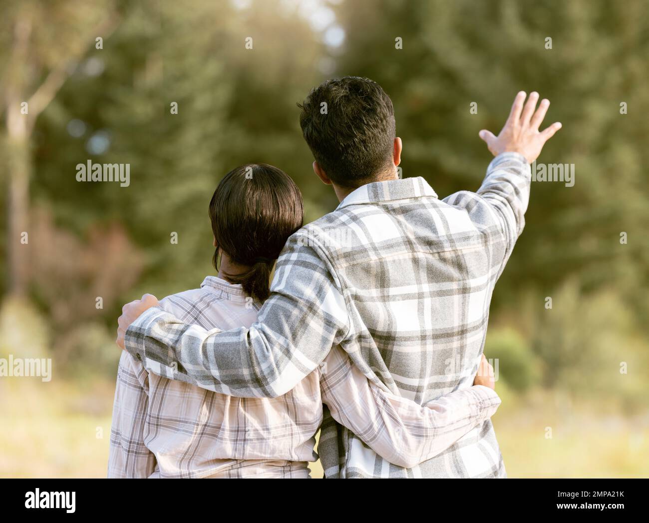 Trees, nature gesture and couple hug on outdoor quality time together, hiking adventure or forest bonding journey. Peace, freedom and love for back of Stock Photo