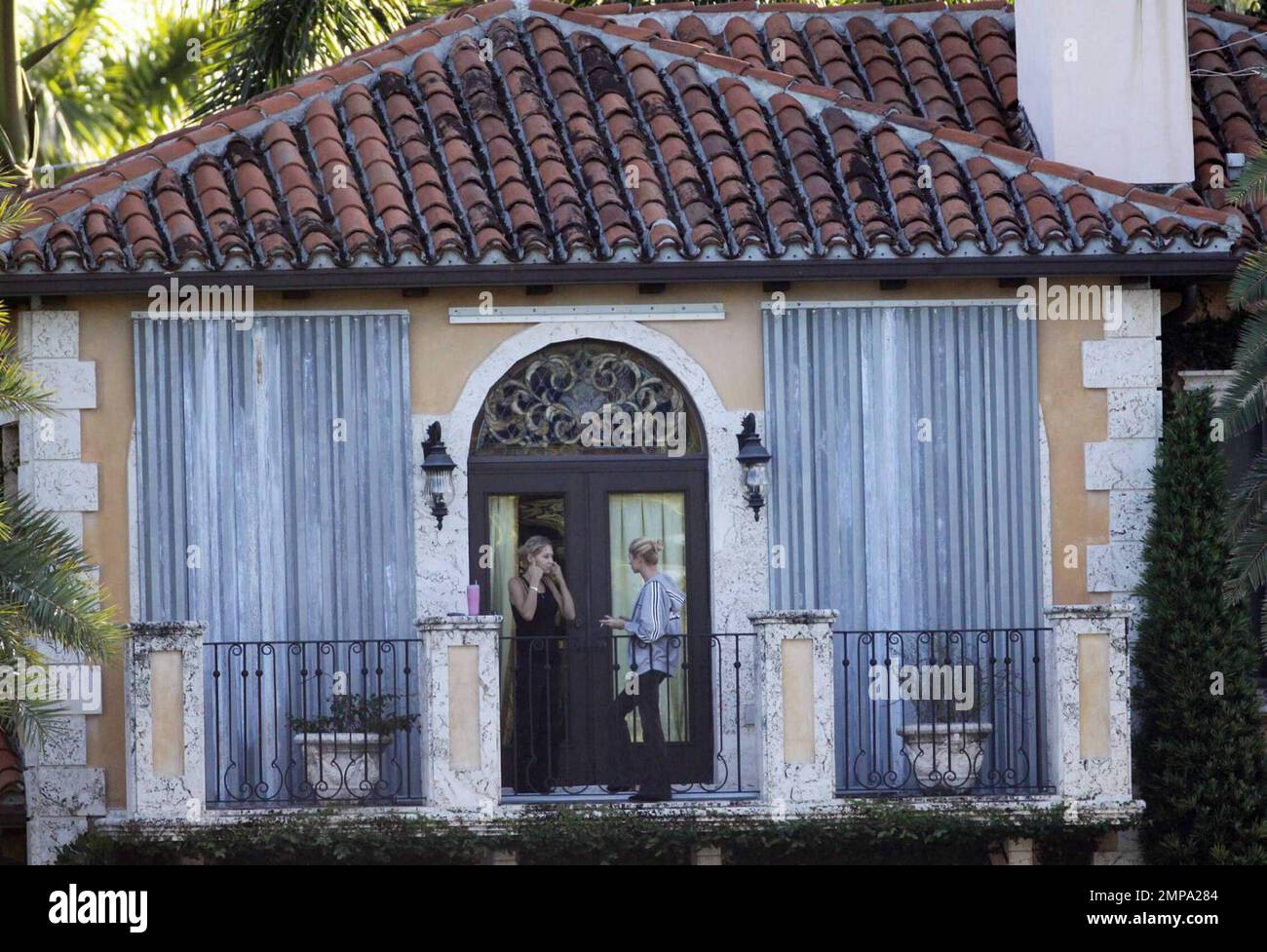 EXCLUSIVE!! Despite recent rumors of pregnancy, Anna Kournikova was spotted  on the balcony of her beleaguered home smoking a cigarette and looking at  her figure in the reflection of a glass door
