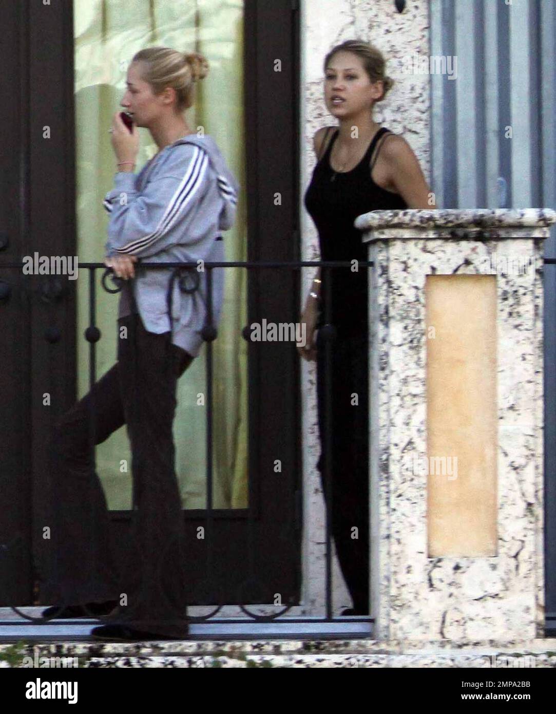 EXCLUSIVE!! Despite recent rumors of pregnancy, Anna Kournikova was spotted  on the balcony of her beleaguered home smoking a cigarette and looking at  her figure in the reflection of a glass door