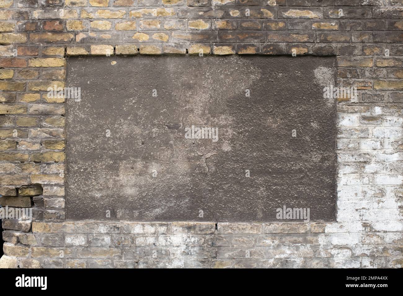 An old brick wall in English bond laid with alternating courses of headers and stretchers. Stock Photo