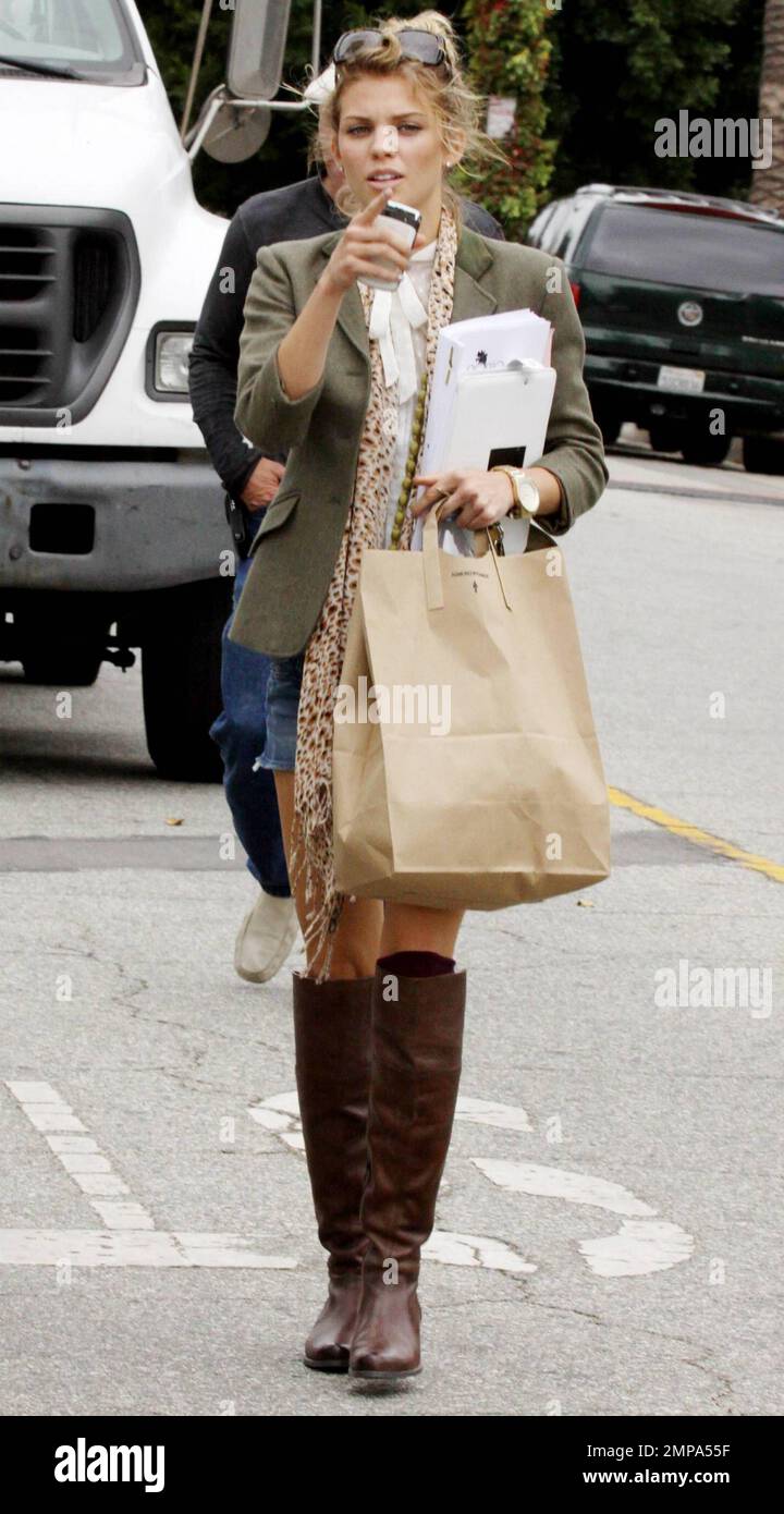 AnnaLynne McCord, who over the weekend reportedly claimed she wants six children, arrives on the set of the teen drama '90210'.  Carrying groceries, a laptop and her script, McCord appears ready to take on the day.  The actress, who is currently dating hunky model and actor Kellan Lutz, also showed off her large gold watch and her great fashion sense in knee high riding boots, a green blazer, shorts and patterned scarf. Los Angeles, CA. 10/05/10. Stock Photo
