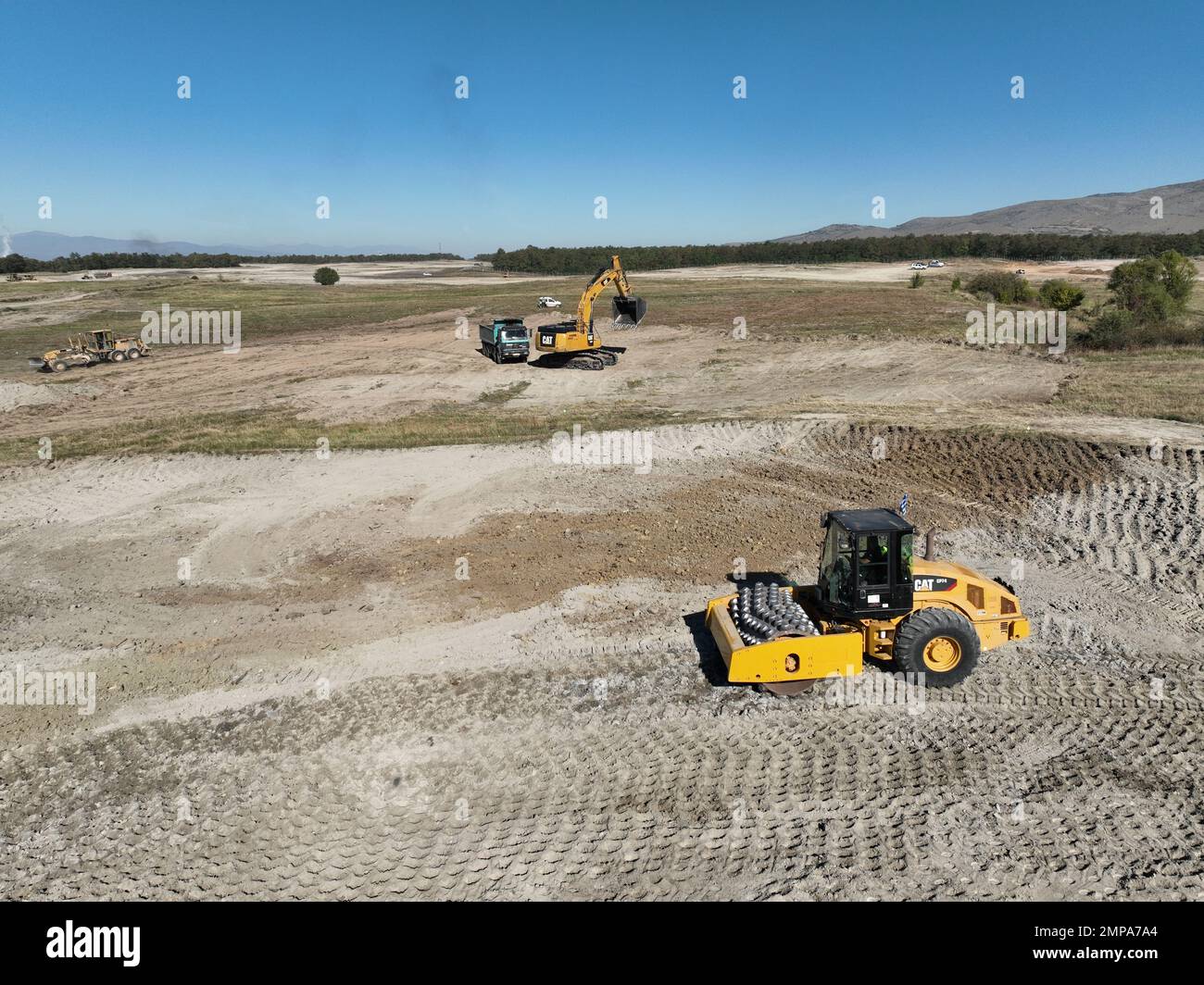Excavator, paver and grader levelling a huge construction site Stock Photo Alamy