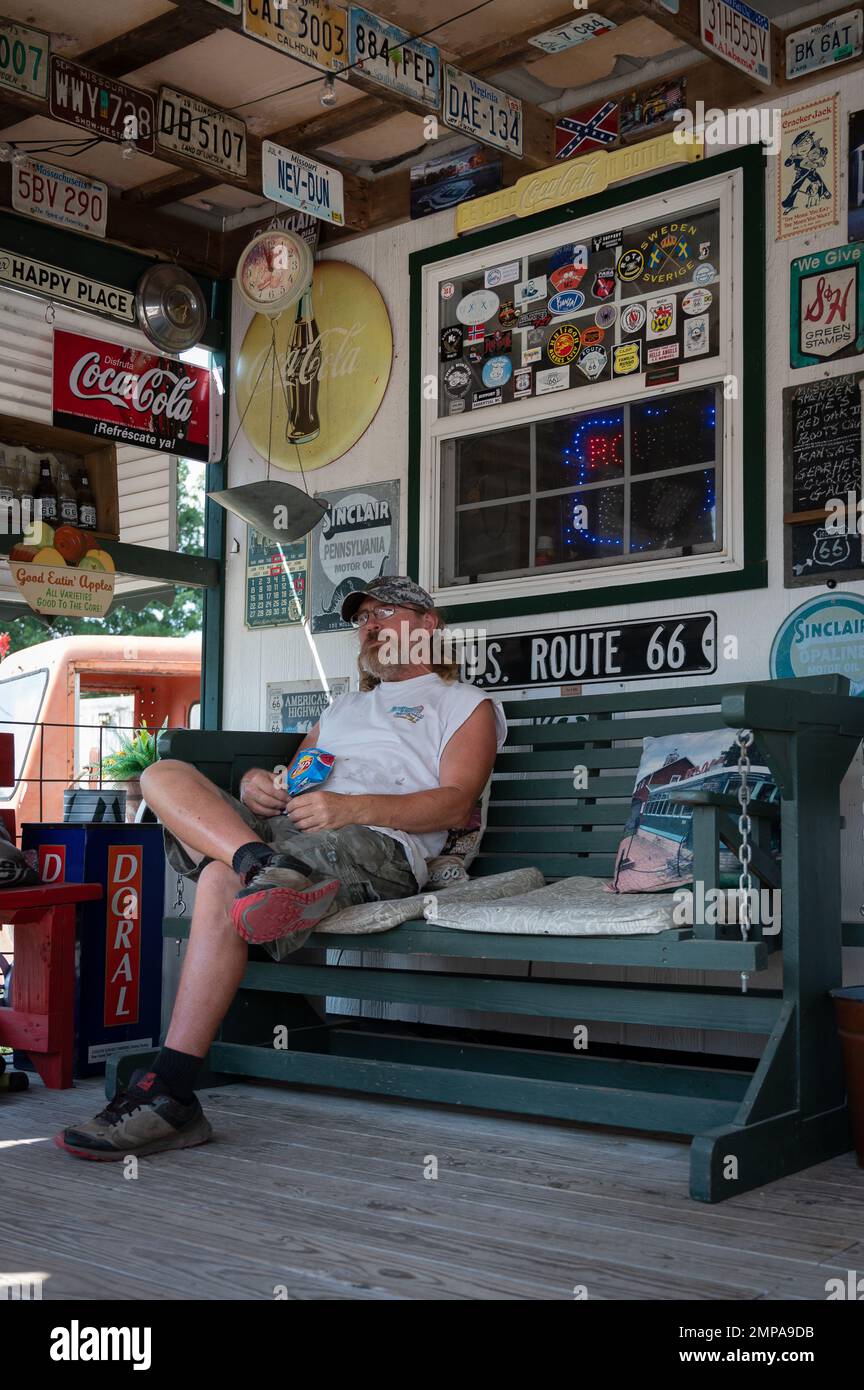 A vertical shot of the owner of the Gary's Gay Parita Sinclair gas