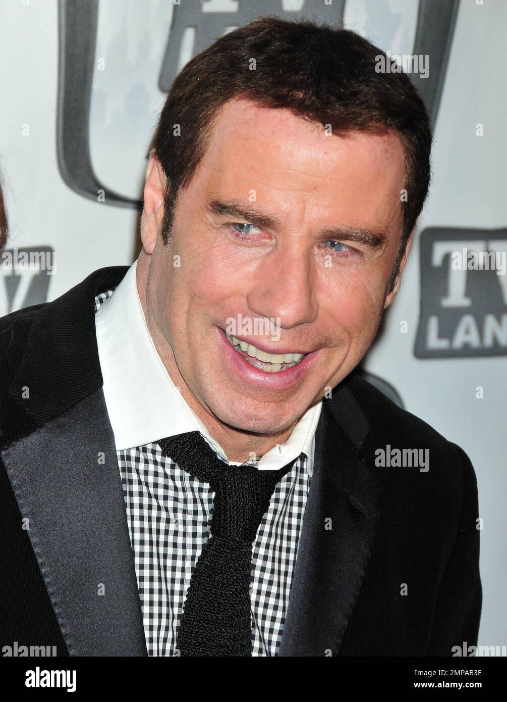 John Travolta appears in a great mood, and sports his hair weave, at the 9th Annual TV Land Awards, held at the Javits Center, and is joined by wife Kelly Preston and the cast of the 1970s TV series "Welcome Back, Kotter". New York, NY. 04/10/11. Stock Photo