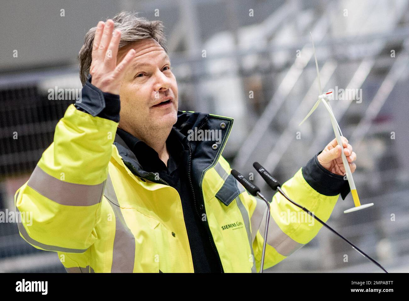 Cuxhaven, Germany. 31st Jan, 2023. Robert Habeck (l, Bndnis 90/Die  Grnen), Federal Minister for Economic Affairs and Climate Protection,  holds the model of a wind turbine he received earlier from the managing