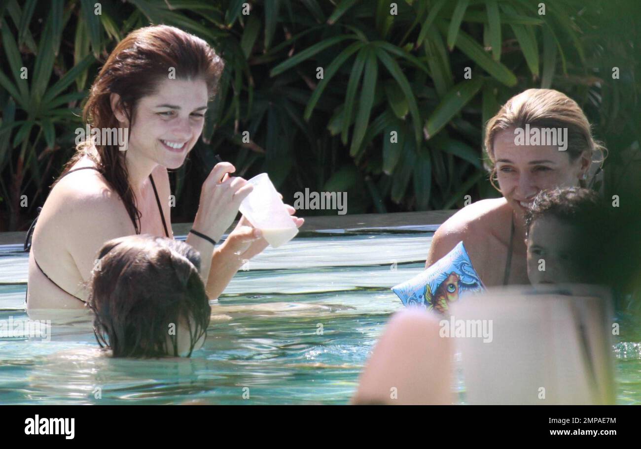 Argentinian model and actress Araceli Gonzalez and boyfriend, Argentinian actor Fabian Mazzei, enjoy time with friends and family poolside at their luxury Miami hotel.  Gonzalez chilled in her bikini and sipped on a fruit smoothie as she waded in the pool and almost popped out of her bikini top. Miami, FL. 10/02/10. Stock Photo