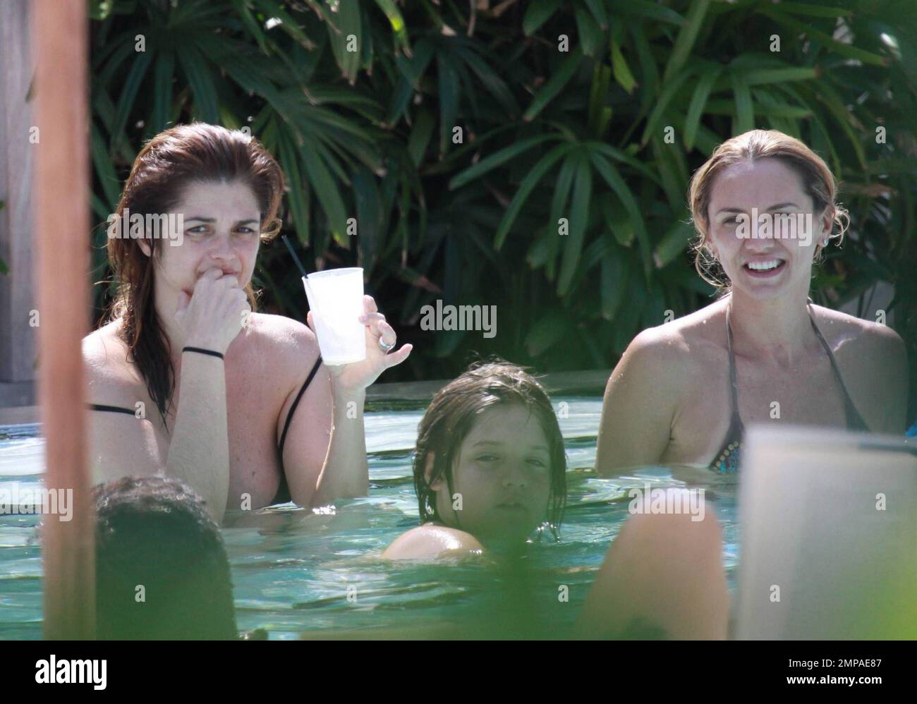 Argentinian model and actress Araceli Gonzalez and boyfriend, Argentinian actor Fabian Mazzei, enjoy time with friends and family poolside at their luxury Miami hotel.  Gonzalez chilled in her bikini and sipped on a fruit smoothie as she waded in the pool and almost popped out of her bikini top. Miami, FL. 10/02/10. Stock Photo