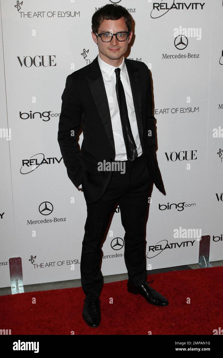 Elijah Wood in geek chic glasses on the red carpet at the star studded Art of Elysium fourth annual Heaven Charity Gala held at the California Science Center. Los Angeles, CA. 01/15/11. Stock Photo