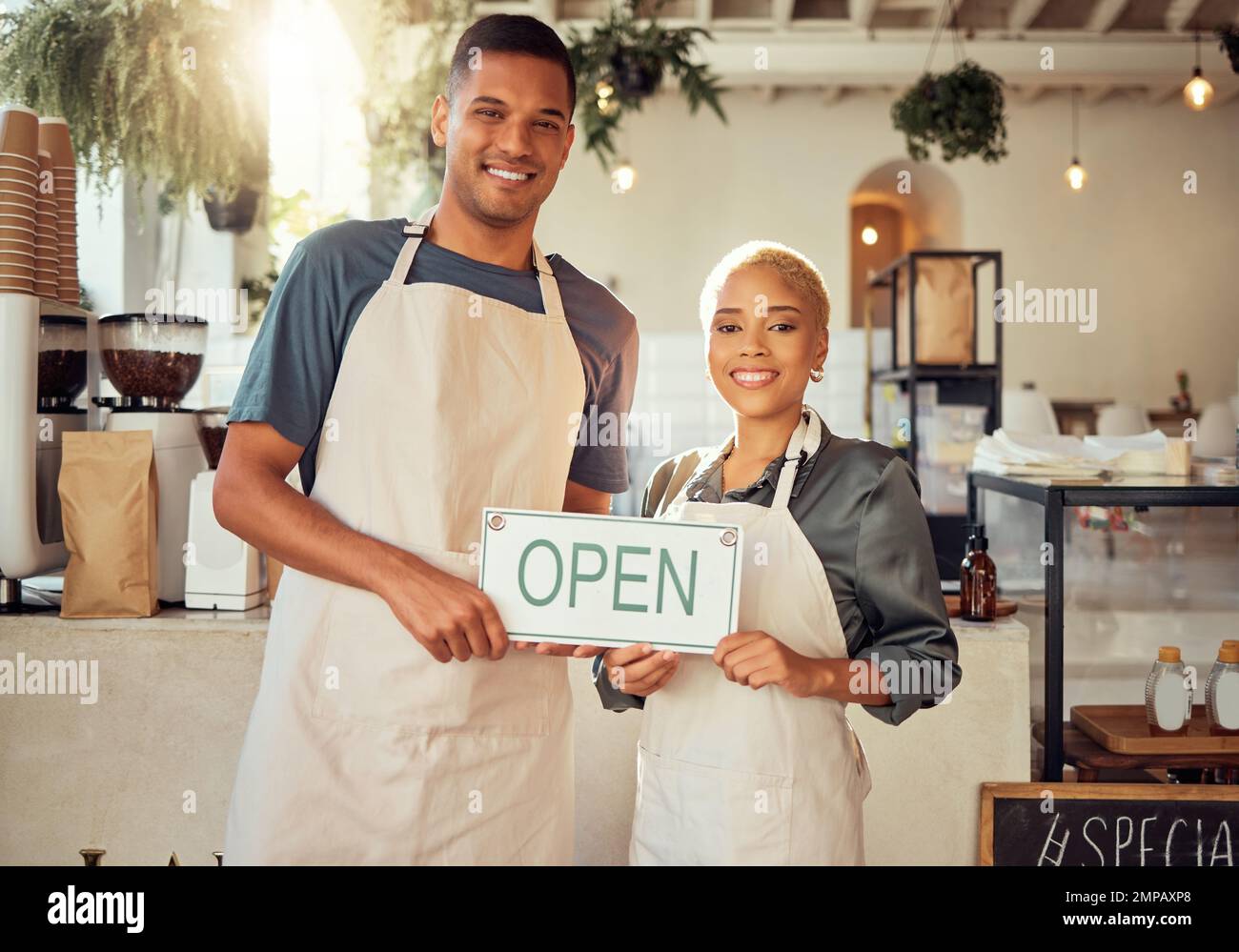 Colleagues, coworkers and small business owners with open sign and happy at restaurant in support together. Team, collaboration and friends smiling Stock Photo