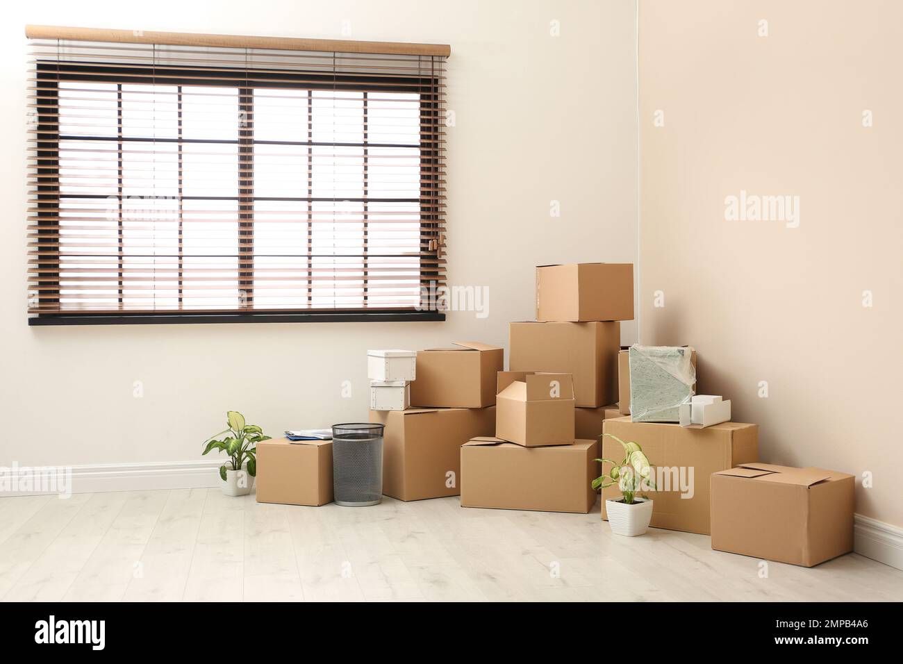 Moving boxes and stuff near window in room Stock Photo - Alamy