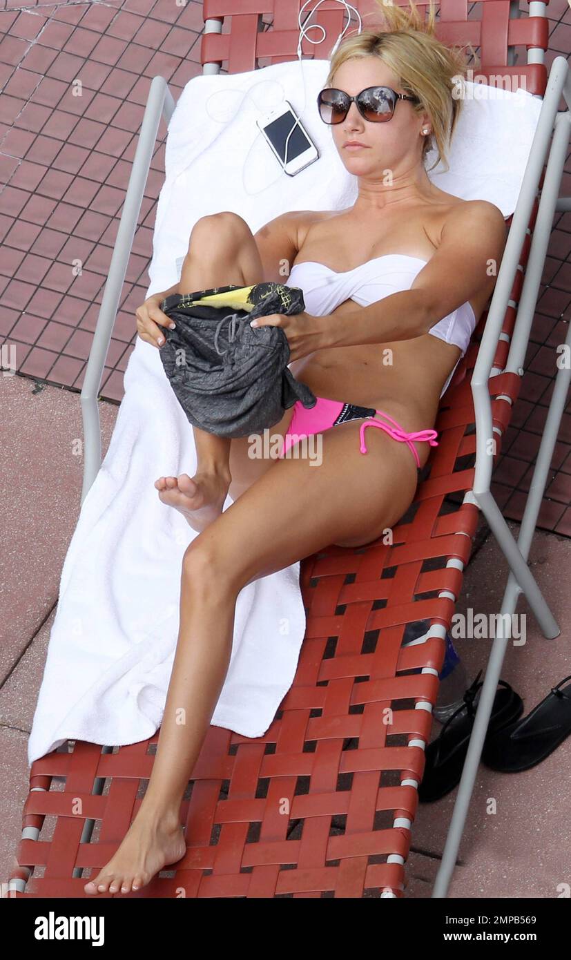 Actress/singer Ashley Tisdale shows off her amazing bikini body as she  spends the afternoon sunbathing by the pool in a pink bikini at her Miami  Beach Hotel. Former Disney star is in