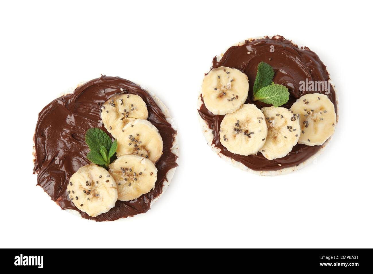 Puffed rice cakes with chocolate spread, banana and mint isolated on