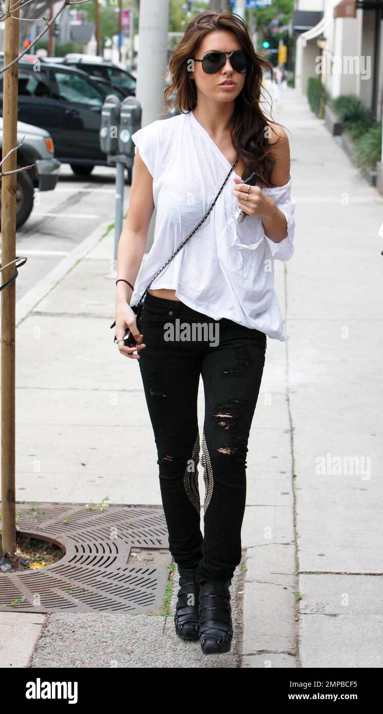 Audrina Patridge dons a trendy off-the-shoulder white tee and ripped ...