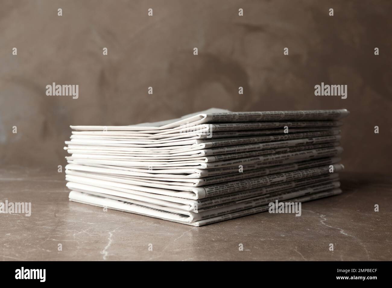 Stack of newspapers on marble table. Journalist's work Stock Photo