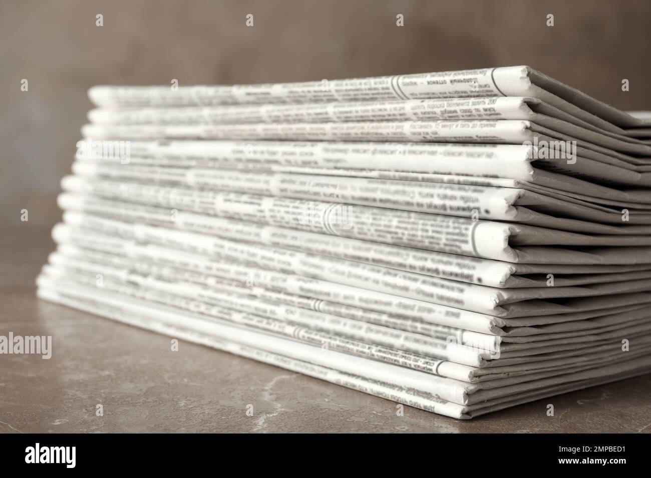 Stack of newspapers on marble table, closeup. Journalist's work Stock Photo