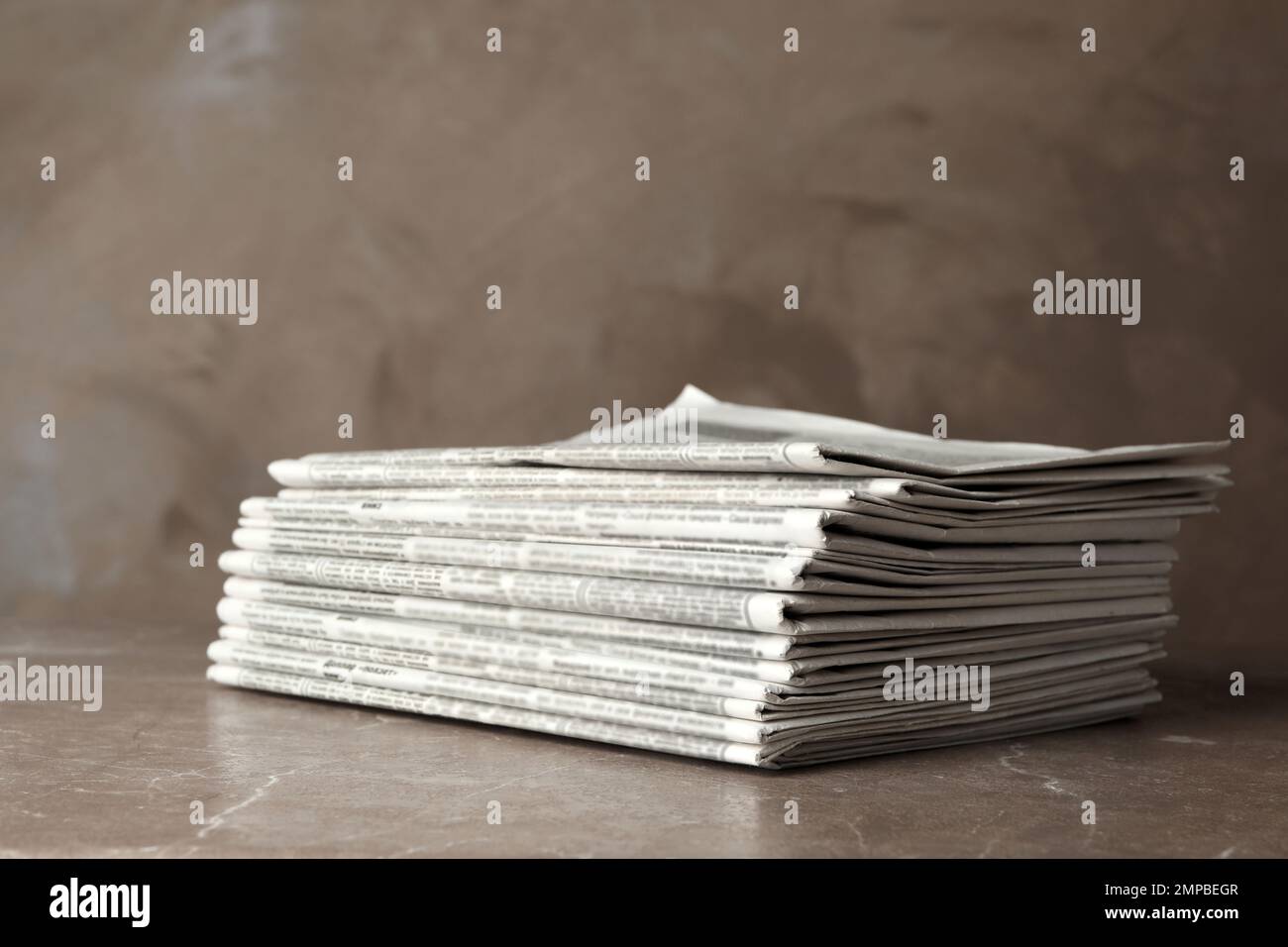 Stack of newspapers on marble table. Journalist's work Stock Photo