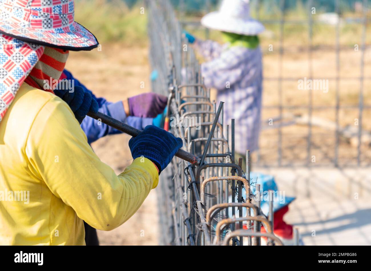 Worker keeps bending the metal rod in his hand with metal bend tools