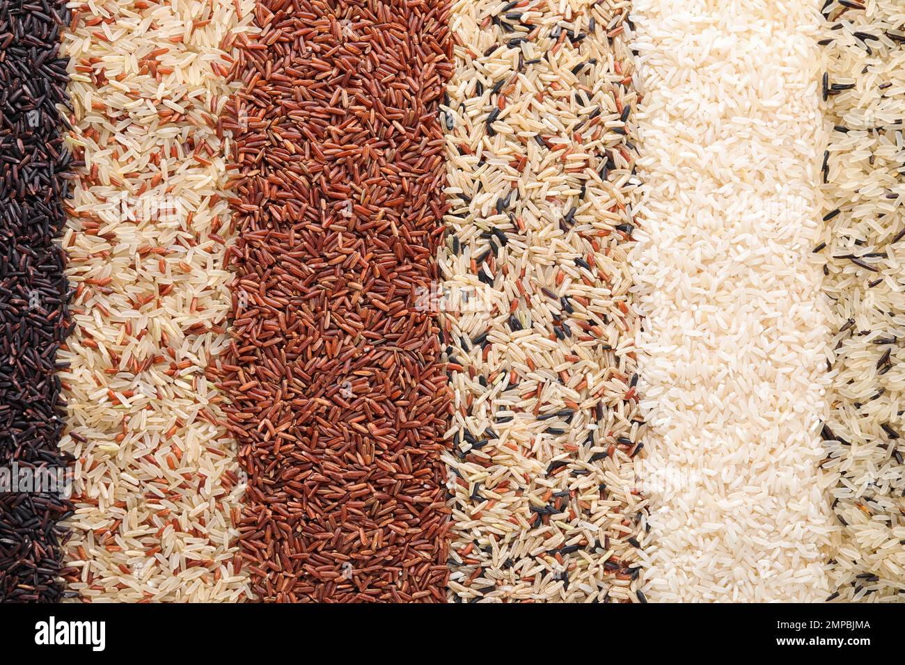 Different types of rice as background, top view Stock Photo - Alamy