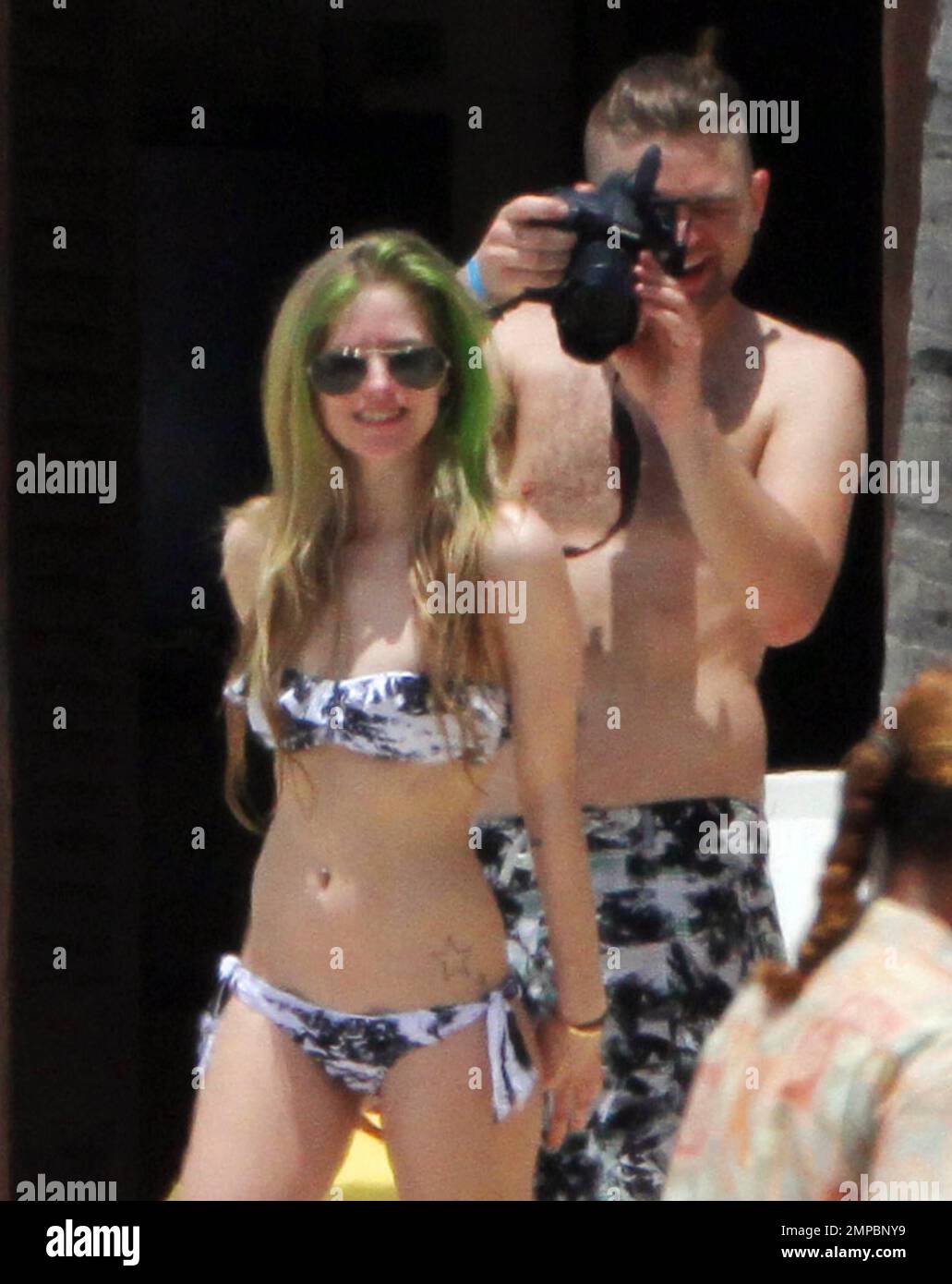 EXCLUSIVE!! Avril Lavigne shows off her fit figure in a black and white  bikini during a beach break with her band and her brother, Matt Lavigne, at  the Atlantis Paradise Island Resort