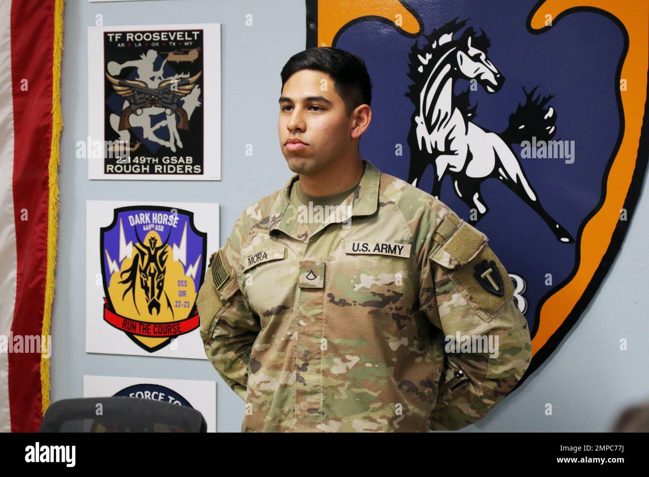 U.S. Army Pfc. Antonio Mora, automated logistical specialist, 92A, for Alpha Company, 449th Aviation Support Battalion, 36th Combat Aviation Brigade, “Task Force Mustang,” 36th Infantry Division, is recognized as “Hero of the Week” by Task Force Mustang, during a command and staff meeting held at Task Force Mustang headquarters in Camp Buehring, Kuwait, Oct. 12, 2022. Mora, native of Laredo, Texas, was recognized for performing duties outside of his primary MOS, involving accurate receipt, storage, issue, accountability, and preservation of numerous individual, organizational, installation, an Stock Photo