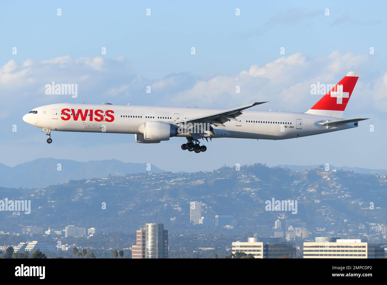 Swiss Airlines Boeing 777 landing. Airplane 777-300ER of Swiss Air Lines flying. Stock Photo