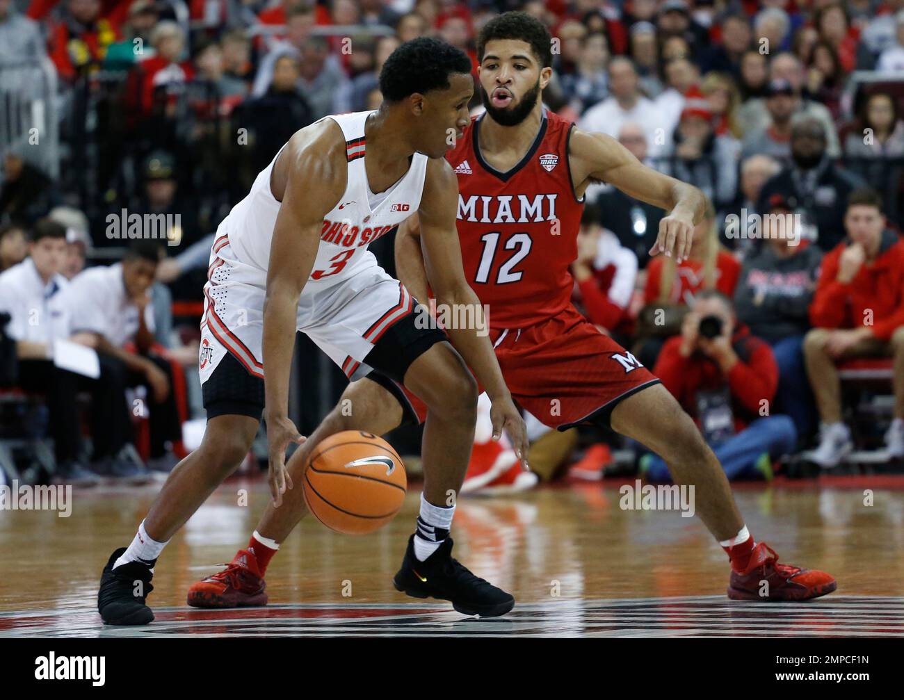 Ohio State's C.J. Jackson, left, looks for an open pass as Miami of Ohio's Darrian Ringo defends during the first half of an NCAA college basketball game Saturday, Dec. 30, 2017, in Columbus, Ohio. (AP Photo/Jay LaPrete) Stock Photo