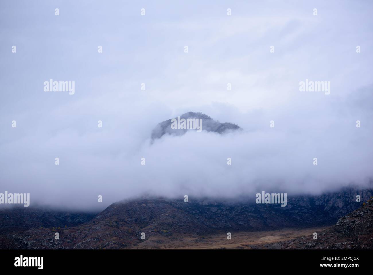 Lonely fog shrouded mountain hi-res stock photography and images - Alamy