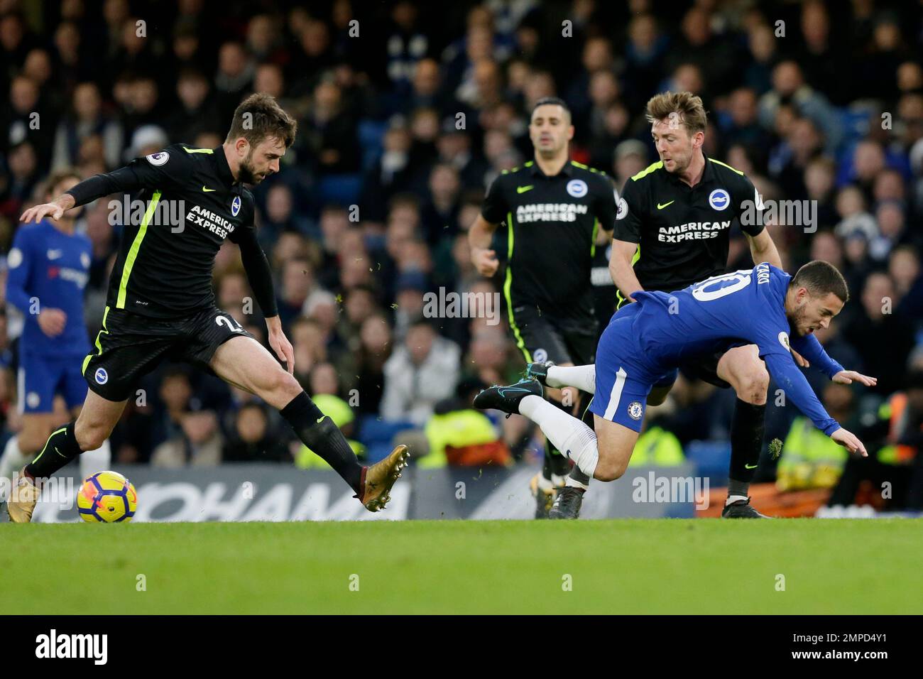 Chelsea's Eden Hazard, right, falls after he was tackled by Brighton's ...