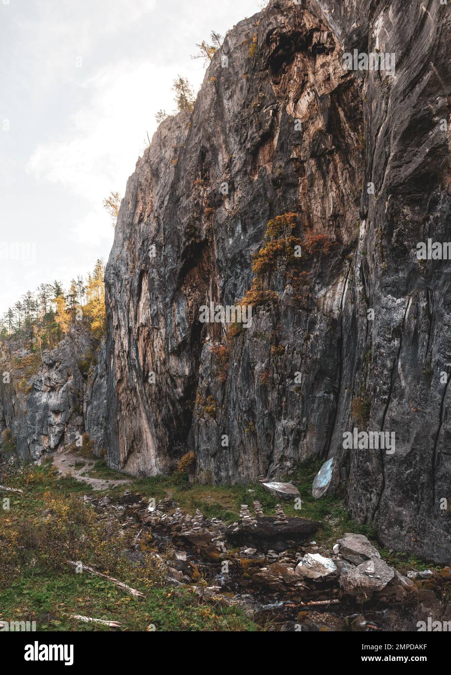 Stones, heaped on top of each other, along the path in the summer go to ...
