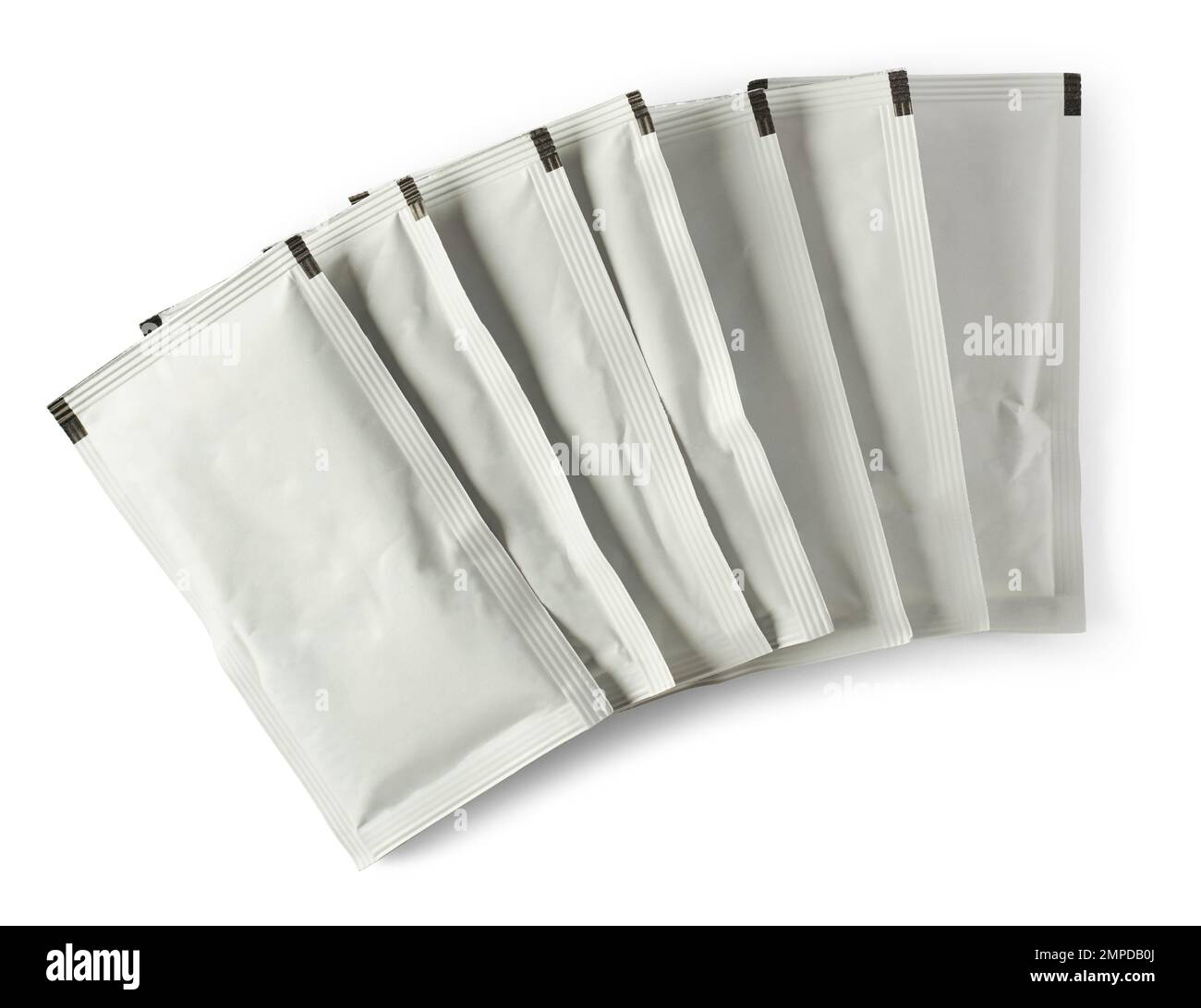 stack of blank white sachet packets isolated on white background, close-up of food or medicine drug packaging mockup template Stock Photo