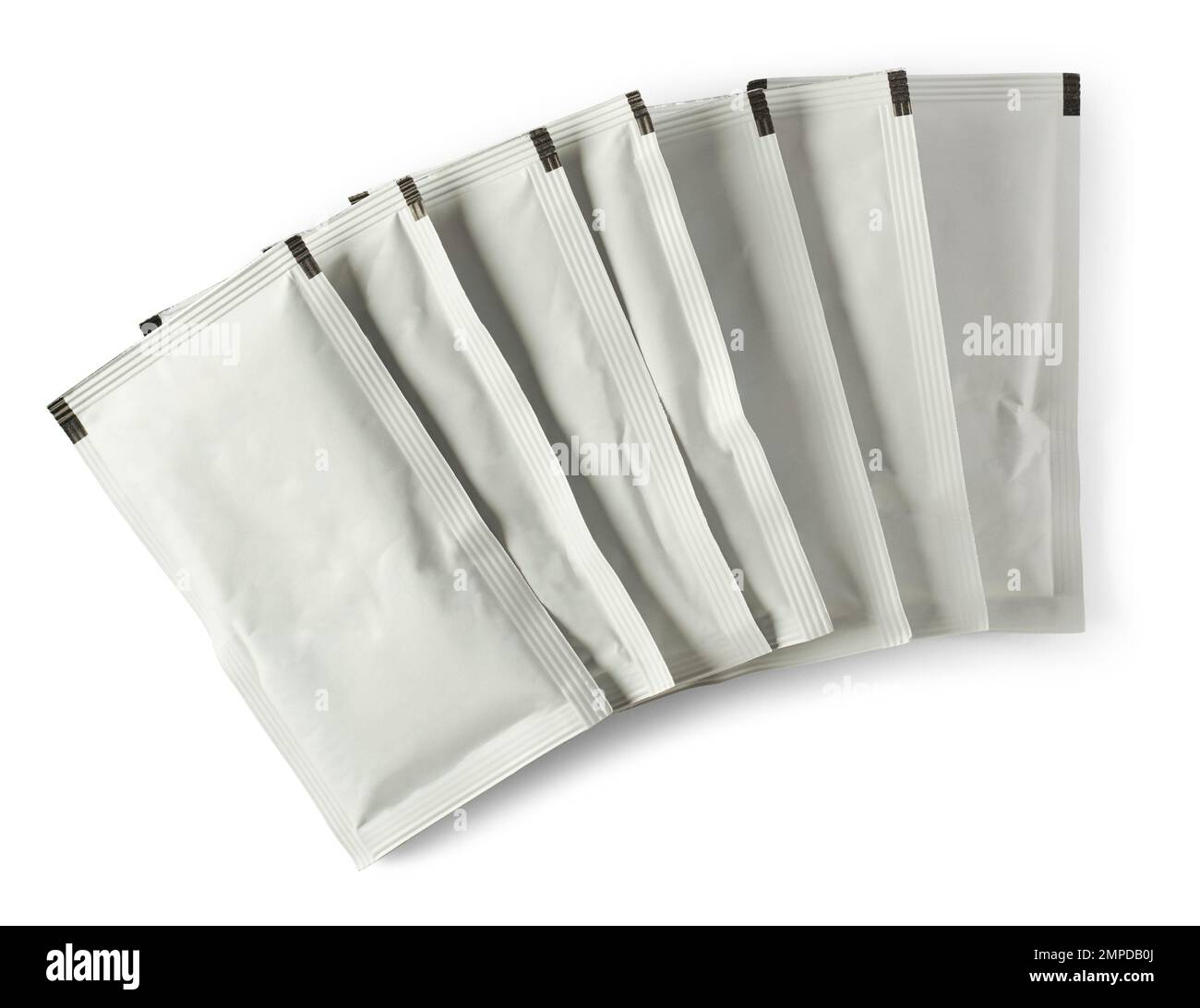 stack of blank white sachet packets isolated on white background, close