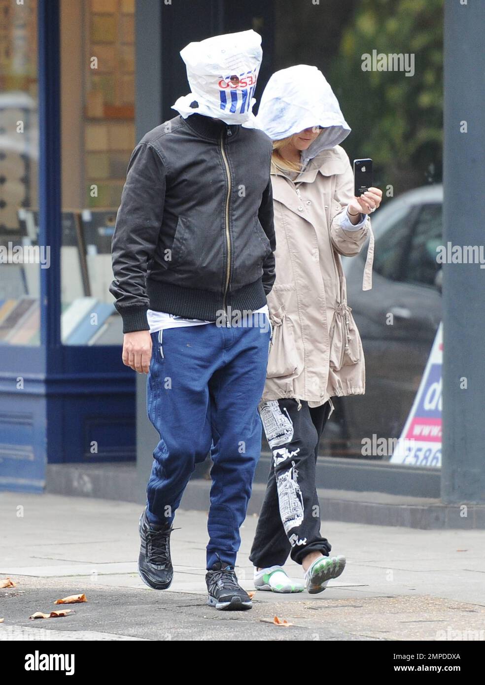 Kate Hudson and Matt Bellamy do their best to hide from photographers as  they take a stroll in Primrose Hill. Matt wore a Tesco shopping bag on his  head while Kate opted