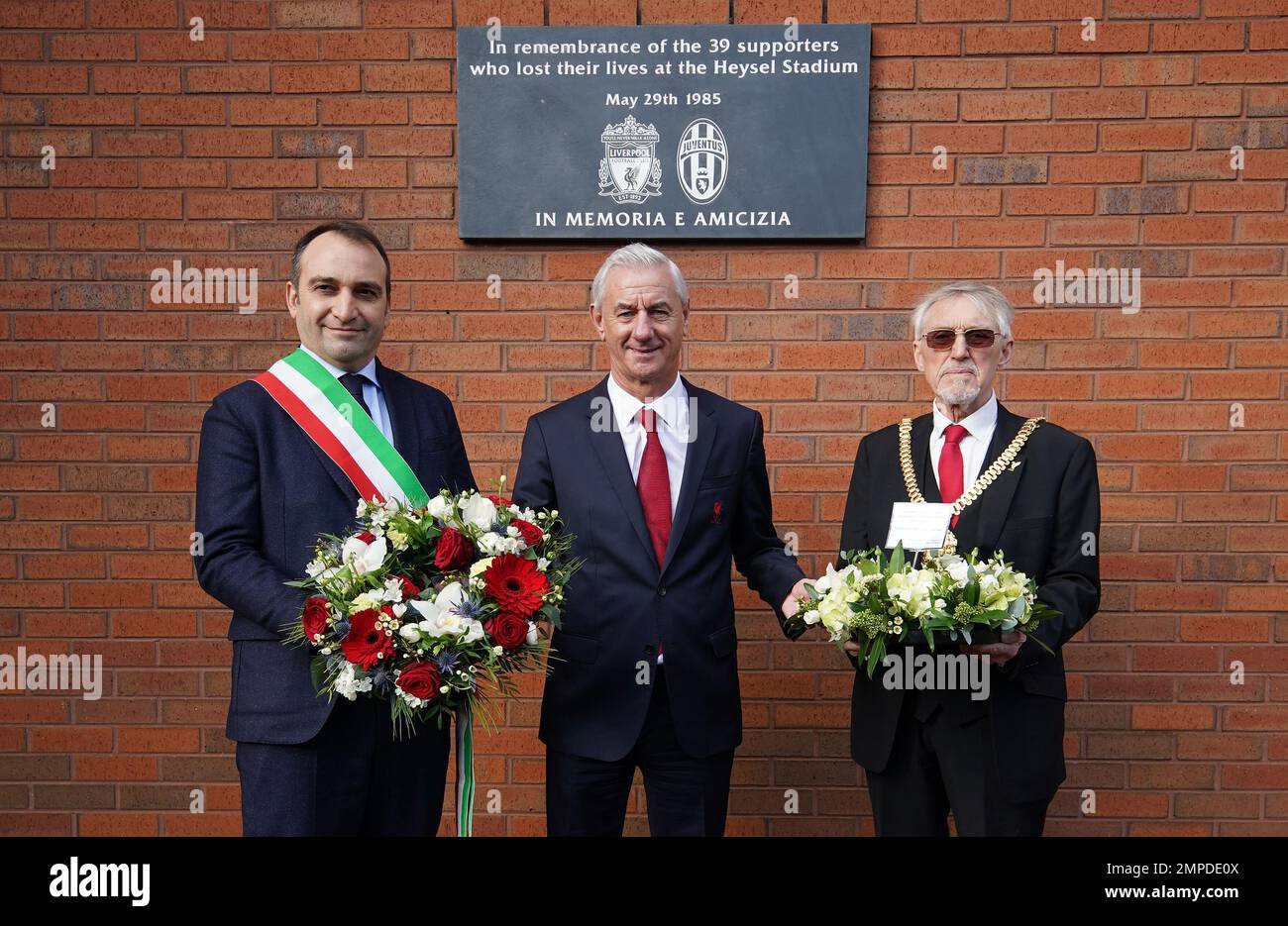 (left to right) Mayor of Turin Stefano Lo Russo, Liverpool FC and former Juventus player Ian Rush and Lord Mayor of Liverpool Cllr Roy Gladden lay a wreath at the Heysel memorial plaque at Liverpool FC's Anfield stadium, in memory of the 39 football fans who lost their lives in the 1985 Heysel Stadium disaster. Picture date: Tuesday January 31, 2023. Stock Photo