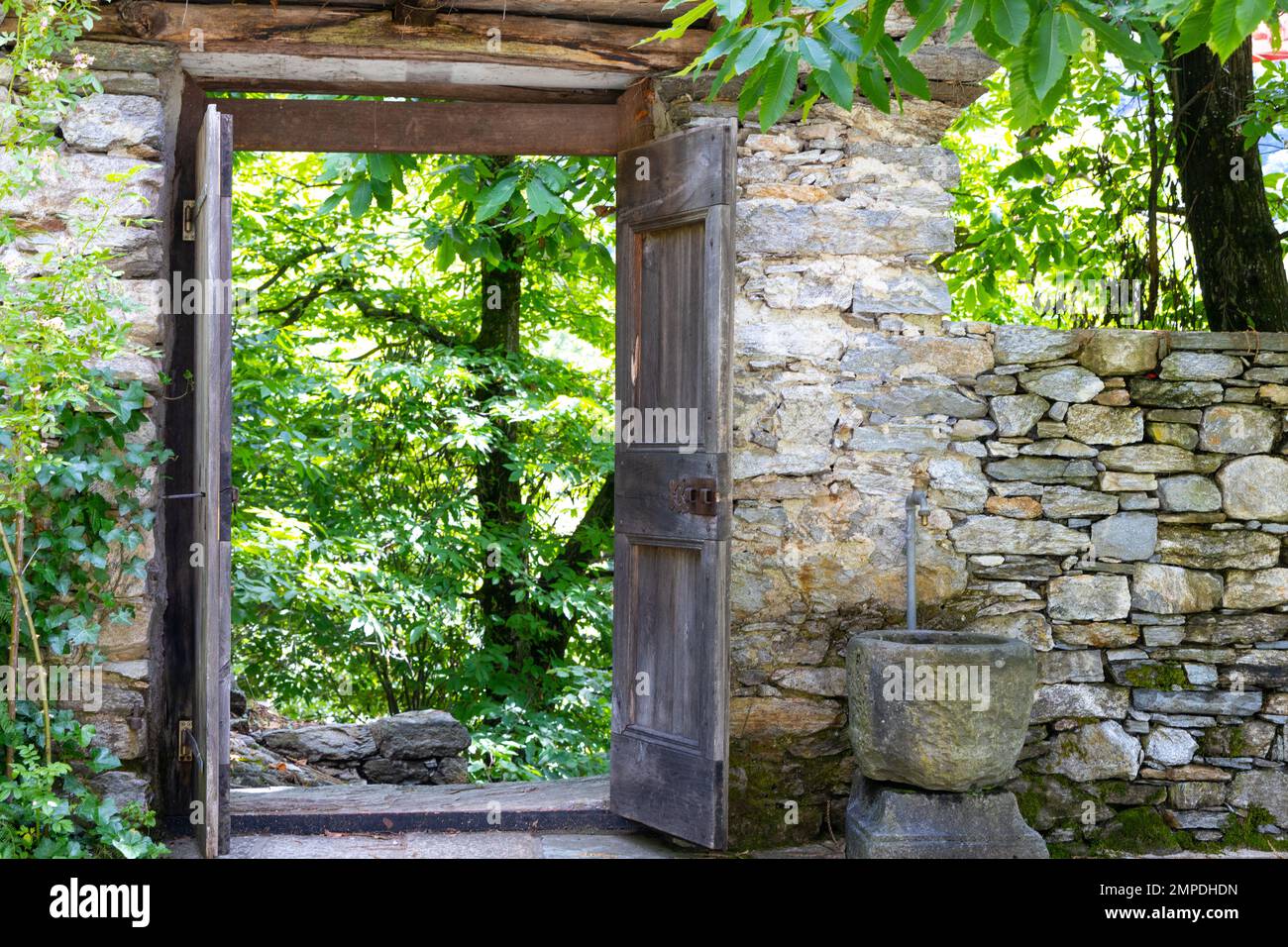 Old wooden door in historic dry stone wall Stock Photo - Alamy