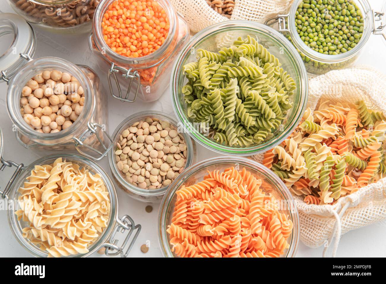 A variety of fusilli pasta made from different types of legumes, green and red lentils, mung beans and chickpeas. Gluten-free pasta. Stock Photo