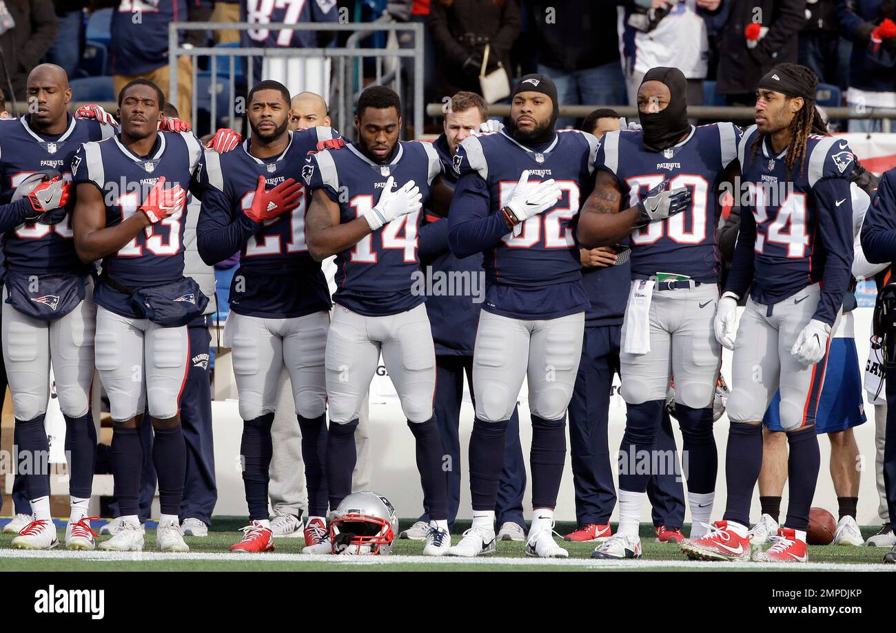 The New England Patriots Stand During The National Anthem Before An Nfl Football Game Against