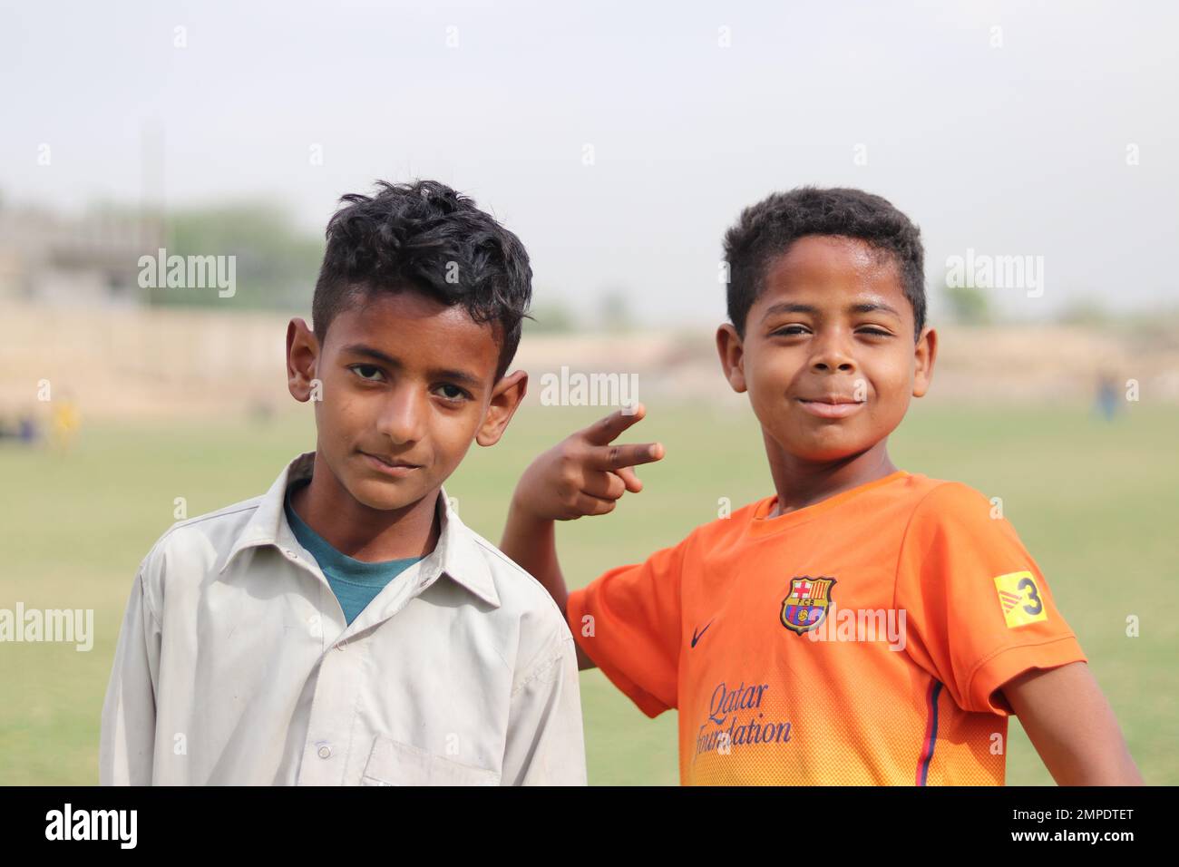 Karachi Pakistan 2019, a kids posing for picture with his blue football