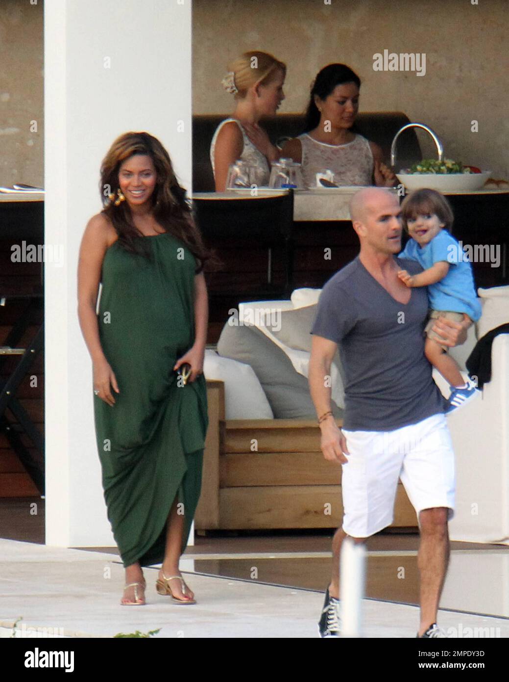 Beyonce Knowles looks positively glowing in a long green maxi dress that  shows off her growing baby bump whilst visiting A Rod's new Miami home with  husband Jay Z and their entourage.