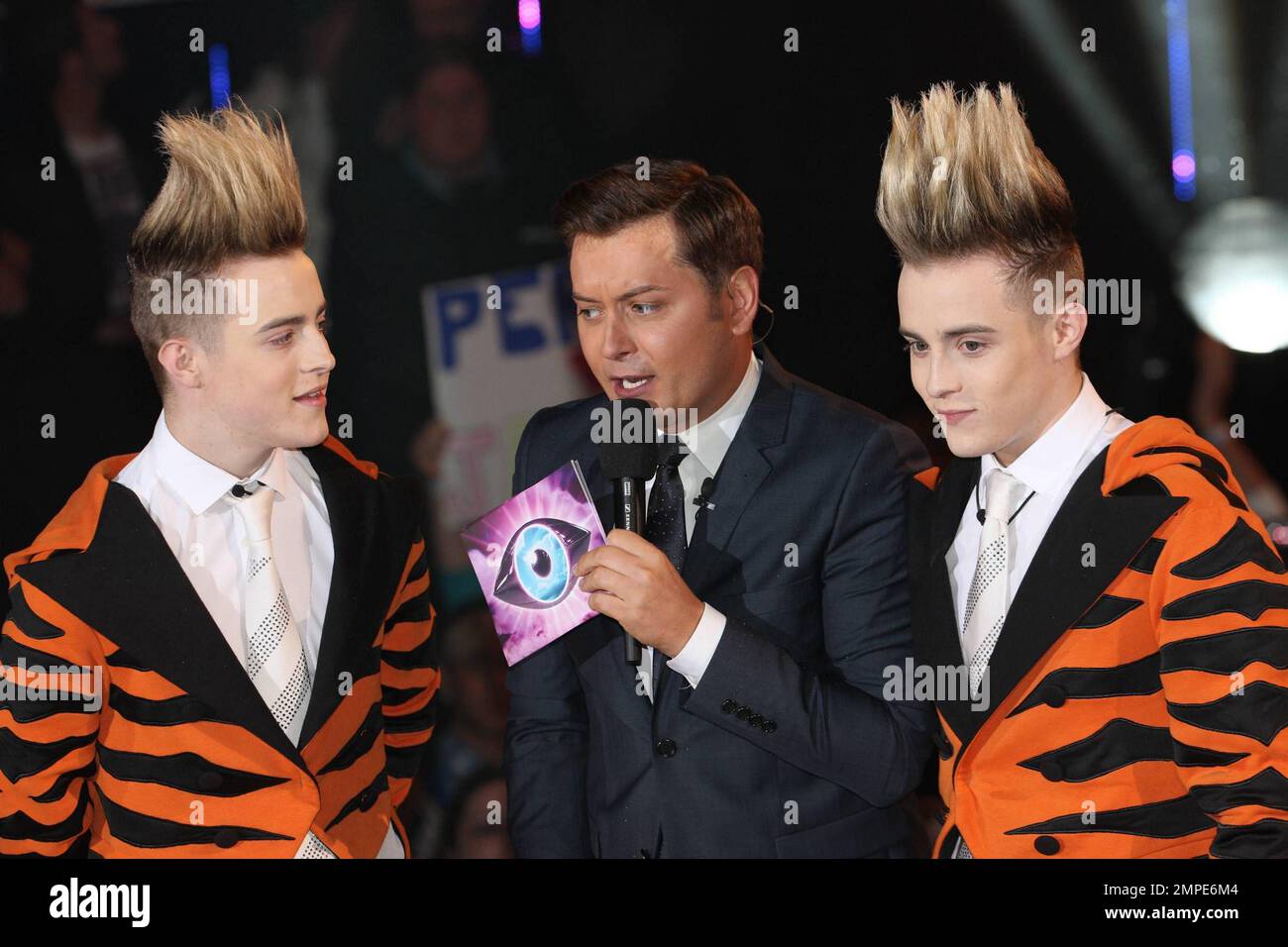 Host Brian Dowling with John and Edward Grimes also know as Jedward as they arrive as a guest in the Big Brother House held at Elstree Studios. London, UK. 18th August 2011. . Stock Photo