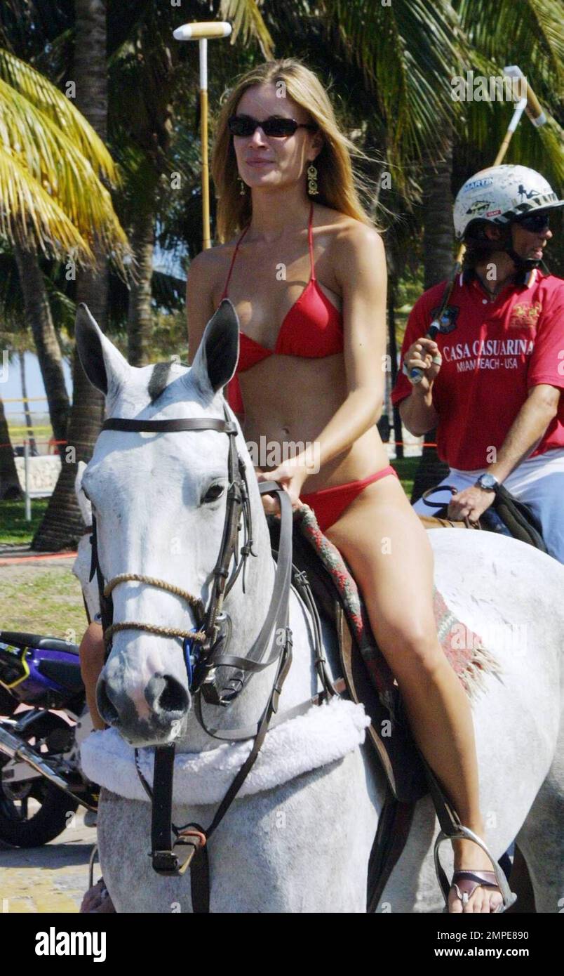 Bikini Clad Girls mount horses to ride in the parade for the launch of the  1st Miami Beach Polo World Cup Tournament hosted by Peter Loftin's private  members club, Casa Casuarina (the