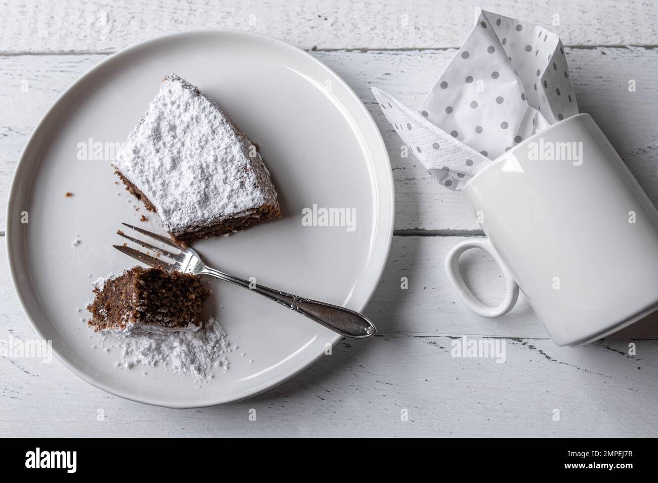 Slice of cake with cup isolated on white background. Flat lay Stock Photo