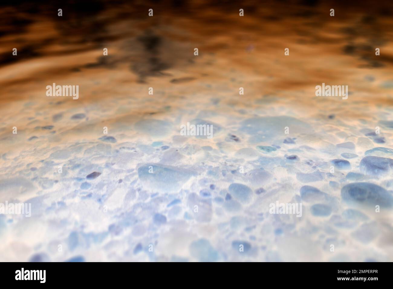 Abstract photo of a transparent water surface with light reflection on ...