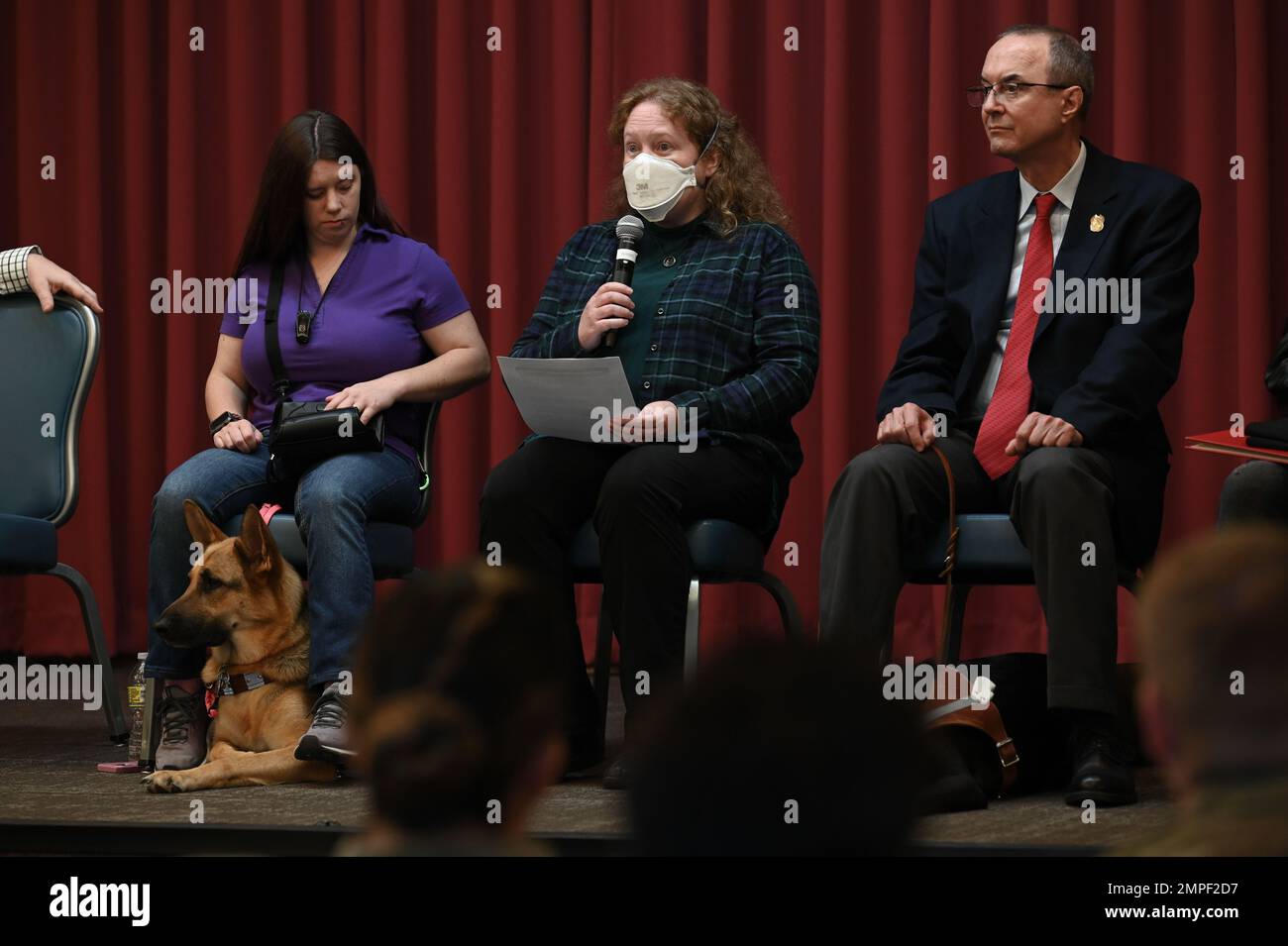 Meagan Gorsuch, Kirtland Air Force Base military spouse (right), and Mike Loats, 377th Air Base Wing Inspector General member (left), listen while Tanya Tavenner, Air Force Research Laboratory member (middle), shares details about her disability during the Hero and Family Appreciation Day event at Kirtland Air Force Base, N.M., Oct. 13, 2022. Loat shared how her extreme fragrance sensitivity affects her everyday life and how she has faced discrimination and hostility. Stock Photo