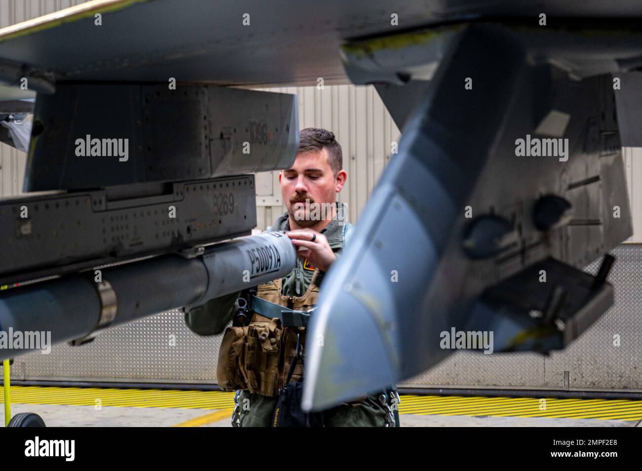 U.S. Air Force Captain Aaron Doyle, 14th Fighter Squadron wing flight safety officer, performs a pre-flight inspection on his F-16 Fighting Falcon at Eielson Air Force Base, Alaska, during RED FLAG-Alaska 23-1, Oct. 13, 2022. The F-16 is an all-weather, extremely maneuverable, tactical fighter designed to permit the Air Force to gain and maintain air supremacy over the battlefield. Stock Photo