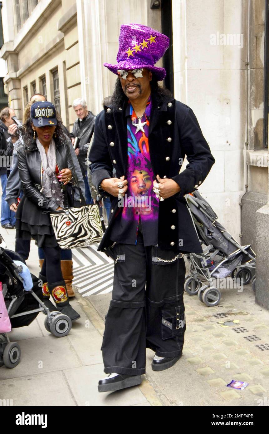 Always the flasy dresser funk music legend Bootsy Collins wears a big purple sequined hat a wildly colorful shirt and black jacket with star shaped sunglasses as he signs autographs at BBC Radio