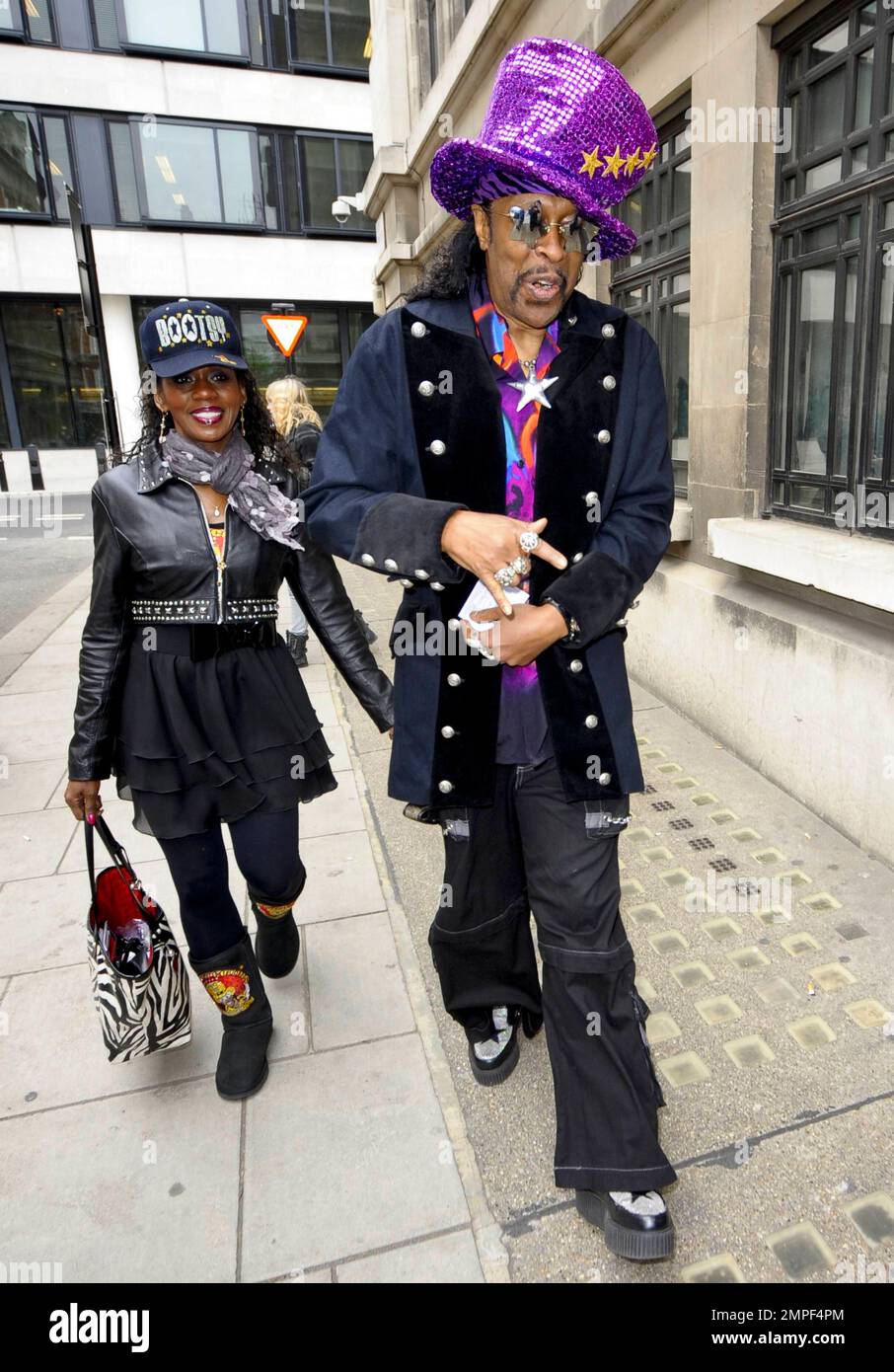 Always the flasy dresser, funk music legend Bootsy Collins wears a big  purple, sequined hat, a wildly colorful shirt and black jacket with  star-shaped sunglasses as he signs autographs at BBC Radio